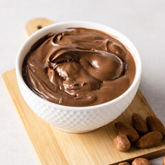 Bowl with Tasty Homemade Nut Butter Hazelnut Almonds and Chocolate Wooden Tray Gray Background Above