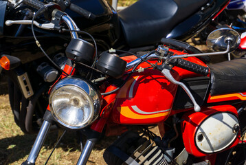 Parked old classic red motorcycle close up