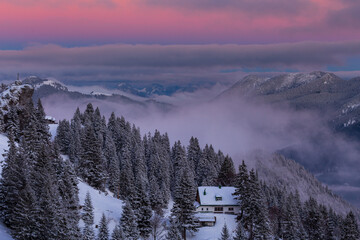 Colorful winter sunset in the Alps, above the inversion and clouds