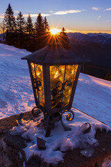 Sun rising behind the lamp making impression of turning it on