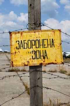 BILA TSERKVA, UKRAINE - AUGUST 25: The sign Restricted Area is on Ukrainian language and view on disassembled Ukrainian Sukhoi Su-24 supersonic aircrafts on August 25, 2021 in Bila Tserkva, Ukraine.