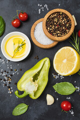Food background from vegetable, spices, herb on black table.