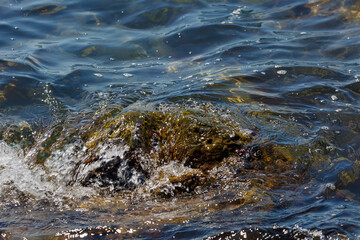 Waves hit a rock in the sea