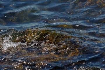 Waves hit a rock in the sea