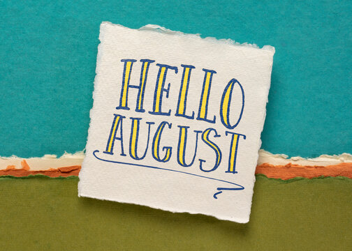 Hello August greeting note  - handwriting on a white handmade paper against colorful abstract landscape, calendar concept