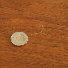 Wood grain texture detail photograph. Euro coin on wood surface.