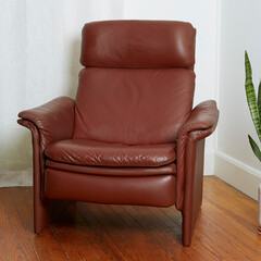 Vintage minimal top grain oxblood leather recliner. Postmodern 1980s stylish chair. Front view in...