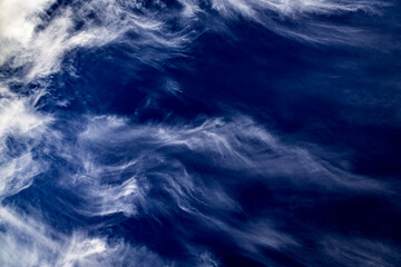 Impressive view of clouds resembling angry waves. Sky and cloud background in waveform. Wavy sky wallpaper.