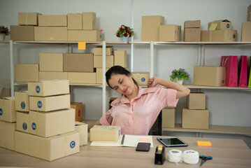 Young Asian worker woman stretch arms while working for a long time in the office.