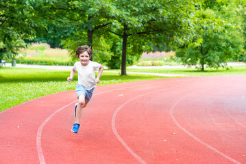 smiling boy  run in the park