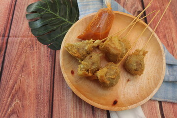 Fried pentol is meatball covered with flour, stabbed and fried, a typical Indonesian food