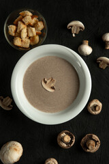 mushroom cream soup in white bowl on black desk
