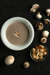 mushroom cream soup in white bowl on black desk