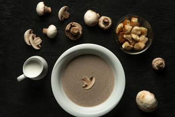 mushroom cream soup in white bowl on black desk