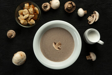 mushroom cream soup in white bowl on black desk