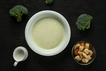 broccoli cream soup in white bowl on black desk