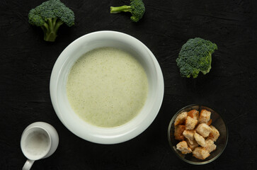 broccoli cream soup in white bowl on black desk