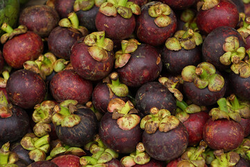 healthy and fresh mangosteen neatly arranged for sale in traditional markets. fresh fruit background