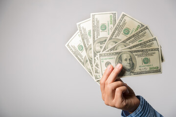 Close up of woman hand holding 100 dollar bills. success business female happy with many money...