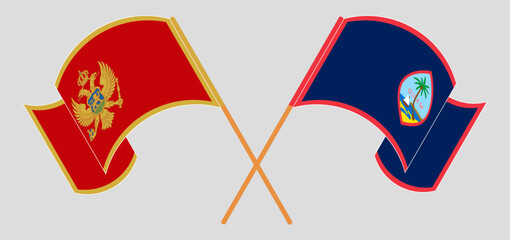 Crossed and waving flags of Montenegro and Guam
