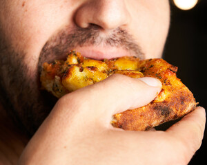 Close-up of man eating Italian pizza. Lifestyle concept.