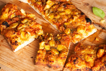 close-up of sliced Italian pizza Traditional food from Palermo, Sicily, Italy. Ingredients Tomato sauce, anchovy, onion, cheese, oregano, oil.
