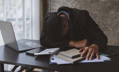 Stress man, business people and work concept, a tired Asian businessman with eyeglasses in office