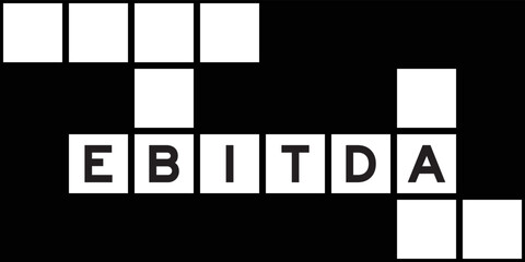 Alphabet letter in word EBITDA (abbreviation of earnings before interest, taxes, depreciation and amortization) on crossword puzzle background