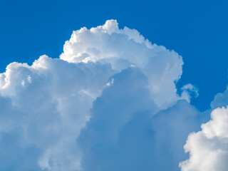 Naklejka na ściany i meble Dence cumulonimbus clouds over the blue sky.