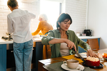 Mature three women spending time together during birthday lunch