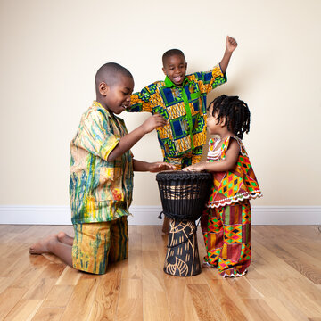 Traditional Ghanaian Fashion. Bright Kente Fabrics From Ghana, West Africa, Being Modelled By Carefree Young Ghanaian Children. Part Of A Series.