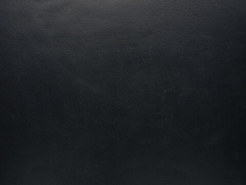 Texture of a fine black leather surface using as luxury background or header
