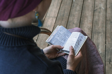 Young religious jewish woman with a headscarf on her head prays with a religious prayer book (51)