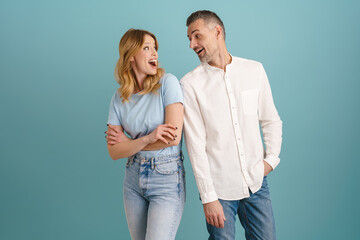 Fototapeta premium White surprised couple exclaiming and looking at each other
