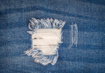 Ripped blue jeans texture background, fashion concept