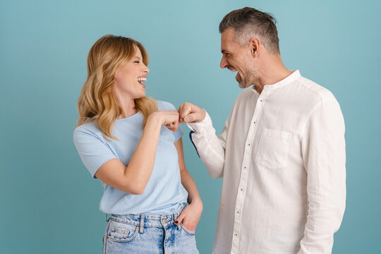 White happy woman and man laughing and hitting each other's fists