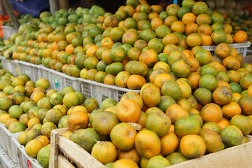 Naklejka na ściany i meble oranges and neat arrangement of fruit in baskets at the traditional market. healthy and fresh orange fruit background