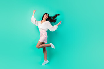 Fototapeta na wymiar Full length photo of cheerful gorgeous girl dancing have good mood isolated on vivid turquoise color background