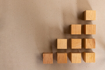 wooden cubes in the shape of a graph with recycled paper background