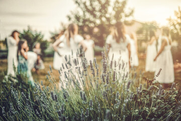 Women in white dresses dancing in nature. Ceremonial dance.
