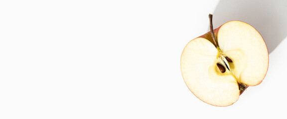 Cut half of an apple on a white background. Top view, flat lay. Banner
