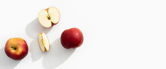 Whole, halves and cut apples on a white background. Top view, flat lay. Banner