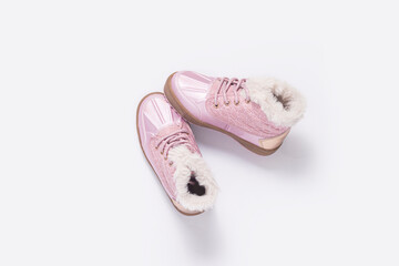 Children's pink shoes on a white background. Top view, flat lay.