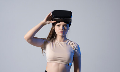 Portrait of young woman wearing a virtual reality headset goggles and ready to play a game with a friends. Future technology concept.