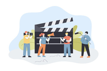 Film making crew shooting video. Tiny male and female characters with equipment and big clapperboard flat vector illustration. Cinema production concept for banner, website design or landing web page
