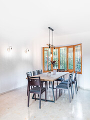 Minimal stylish bright living room with modern table, big windows and retro furnitures. Spacious Scandinavian stylish interior with industrial decor