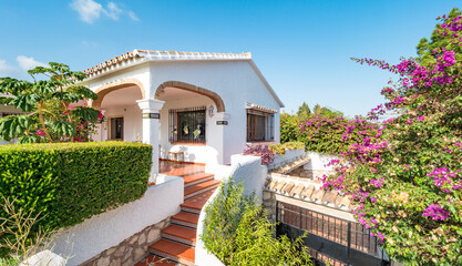 Exterior panorama of the entrance of a relaxing holiday vintage villa with a mediterranean garden