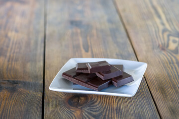 a plate full of chocolate on a wooden table