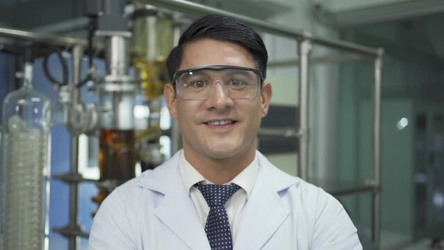 A portrait of scientist man smiling in lab or laboratory in technology medical, chemistry, healthcare, research. Experimental science. People lifestyle.