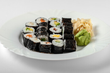 Sushi dish of traditional Japanese cuisine on a white plate, white background